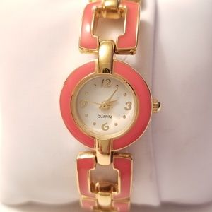 Quartz gold metal and orange band watch.
